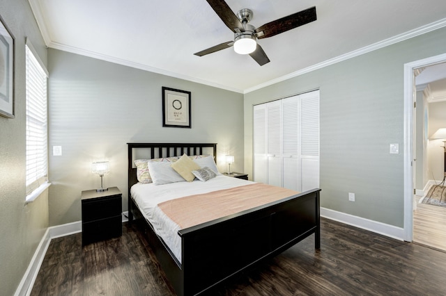 bedroom with multiple windows, dark wood-type flooring, ornamental molding, and a closet