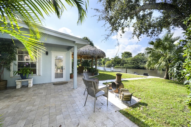 view of patio with a gazebo and a water view