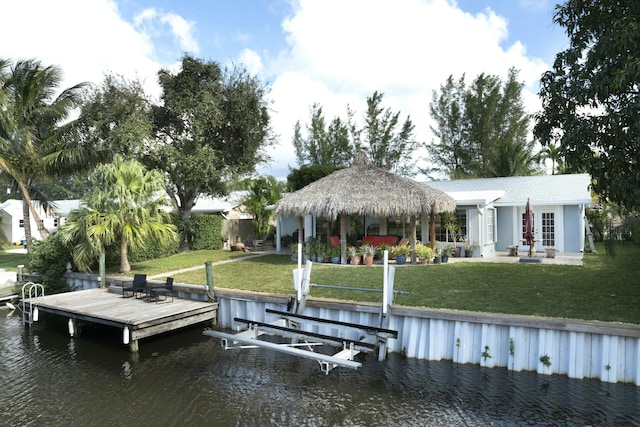 dock area featuring a water view, a gazebo, and a lawn