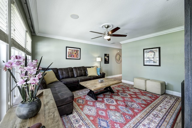 living room featuring crown molding, a textured ceiling, and ceiling fan