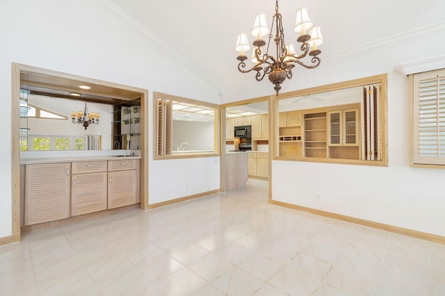 interior space with a notable chandelier, crown molding, vaulted ceiling, and sink