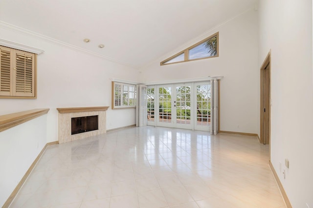 unfurnished living room with french doors, ornamental molding, high vaulted ceiling, and light tile patterned floors