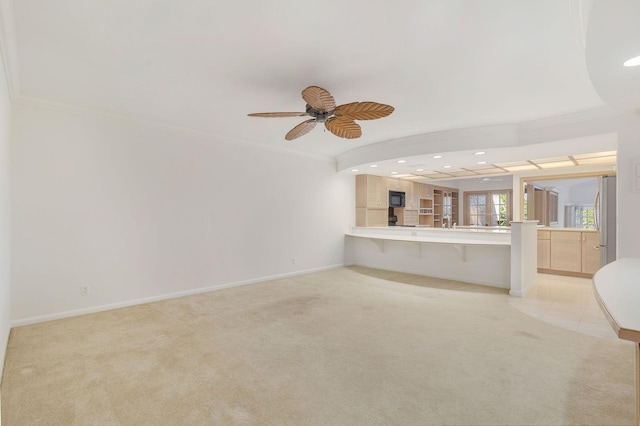 unfurnished living room with crown molding, light colored carpet, and ceiling fan