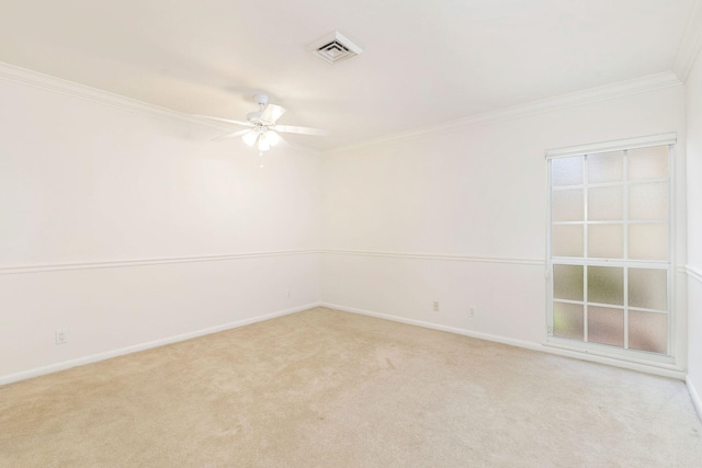 carpeted spare room featuring crown molding and ceiling fan