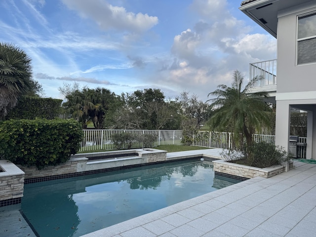 view of swimming pool featuring an in ground hot tub