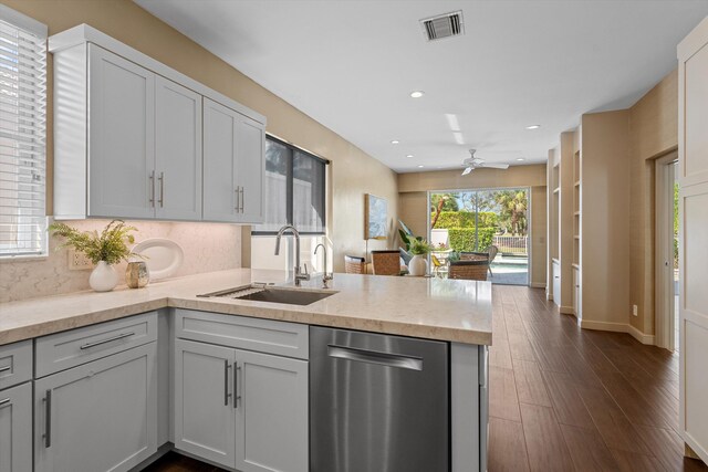 kitchen featuring sink, backsplash, appliances with stainless steel finishes, kitchen peninsula, and white cabinets