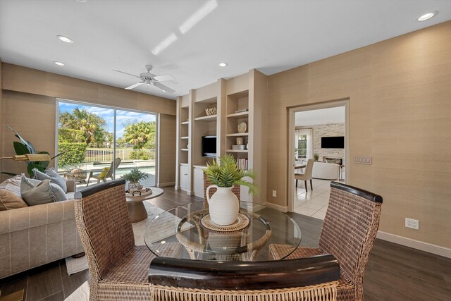 kitchen featuring dark hardwood / wood-style flooring, tasteful backsplash, light stone countertops, black electric cooktop, and stainless steel double oven