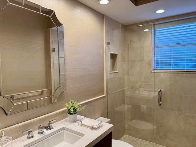 bathroom with vanity, a shower with shower door, and toilet