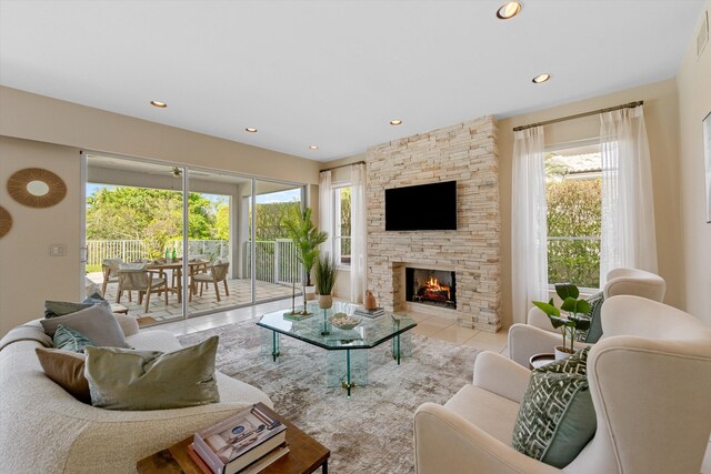 unfurnished living room featuring light tile patterned floors and a stone fireplace