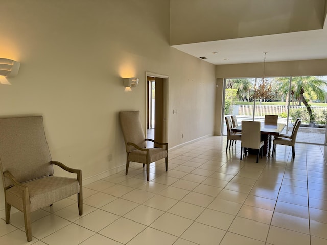 dining area featuring a high ceiling and light tile patterned floors