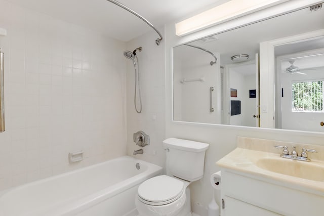 full bathroom featuring vanity, tiled shower / bath, toilet, and ceiling fan