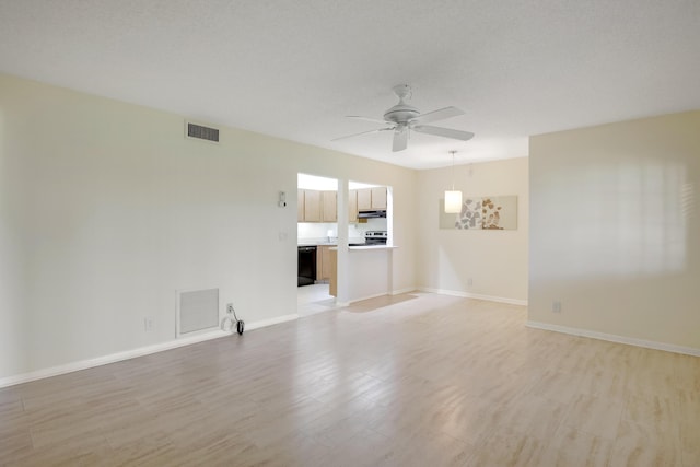 unfurnished living room with a textured ceiling, light hardwood / wood-style floors, and ceiling fan