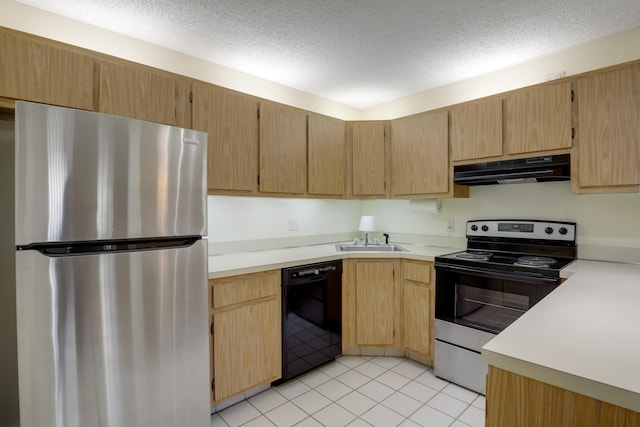 kitchen with appliances with stainless steel finishes, light brown cabinetry, sink, light tile patterned floors, and a textured ceiling