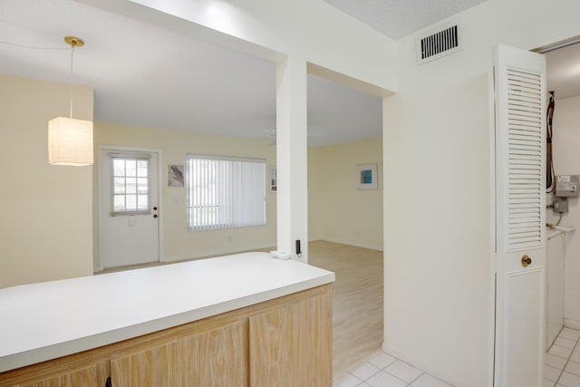 kitchen featuring light brown cabinets and light tile patterned floors