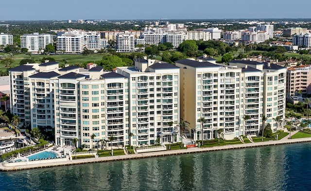 drone / aerial view featuring a view of city and a water view