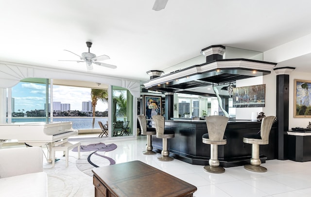 interior space featuring a view of city, bar area, and ceiling fan