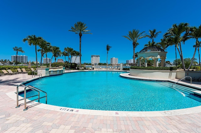 pool with a city view and a patio area