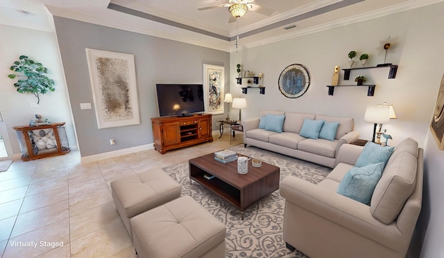 tiled living room featuring crown molding, ceiling fan, and a raised ceiling