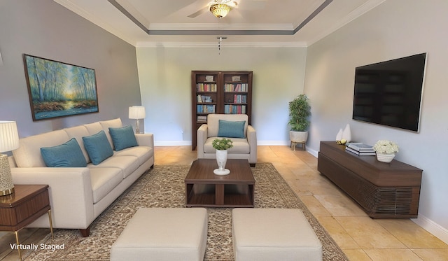 living room with ceiling fan, ornamental molding, and a tray ceiling