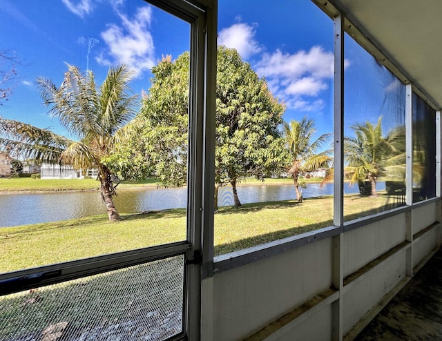 unfurnished sunroom featuring a water view and plenty of natural light