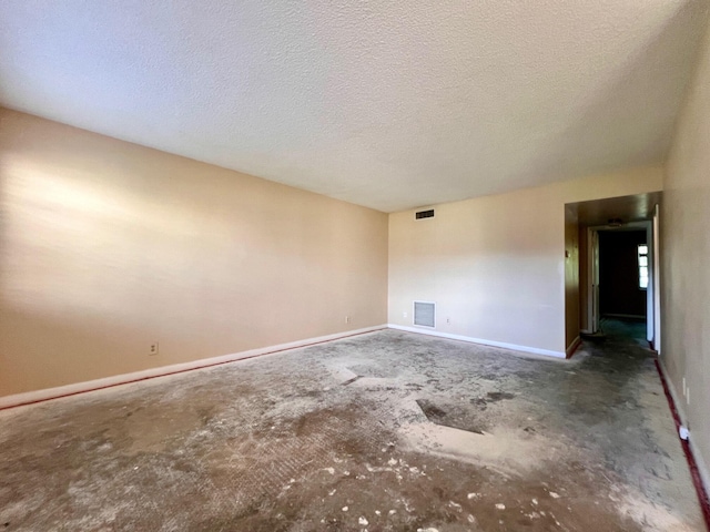 unfurnished room featuring a textured ceiling