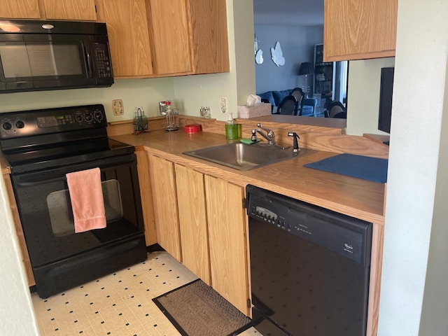 kitchen featuring sink and black appliances