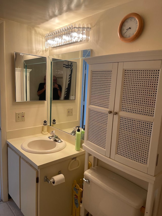 bathroom featuring vanity and toilet