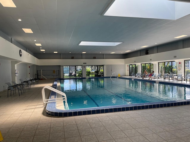 view of swimming pool featuring a skylight