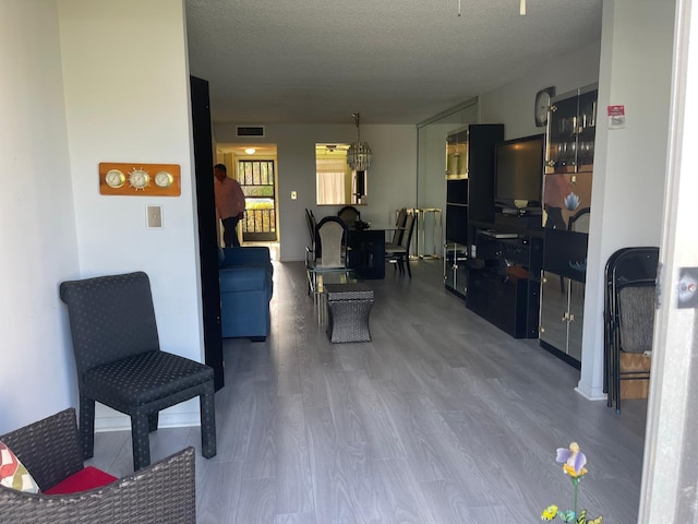 living room with hardwood / wood-style floors and a textured ceiling