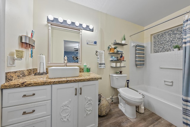 full bathroom with hardwood / wood-style flooring, shower / tub combo with curtain, vanity, and toilet