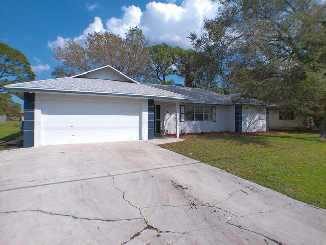 single story home featuring a yard and a garage