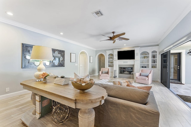 living room featuring ornamental molding and light hardwood / wood-style floors