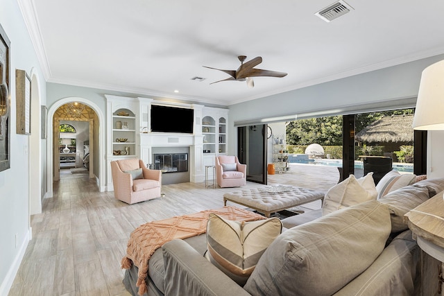 living room with ceiling fan, ornamental molding, and light hardwood / wood-style floors