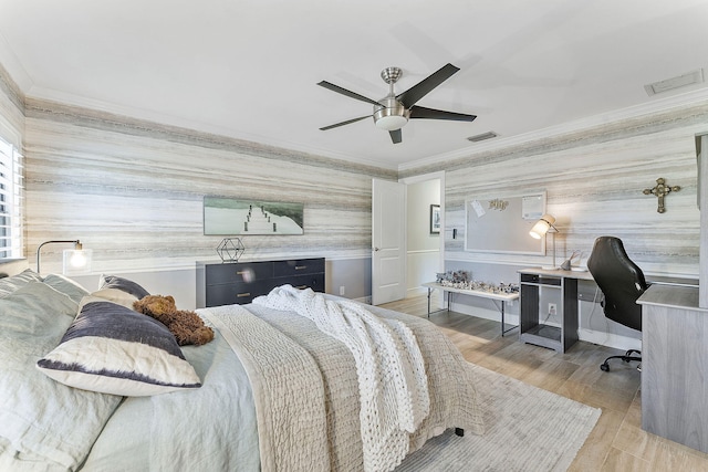 bedroom with ceiling fan, ornamental molding, and light hardwood / wood-style floors