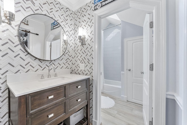 bathroom featuring crown molding, lofted ceiling, shower / tub combo with curtain, and vanity