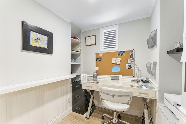 office area with ornamental molding and light hardwood / wood-style floors