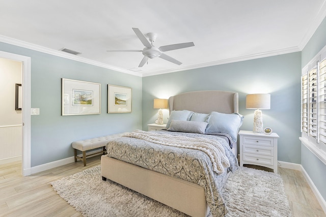 bedroom with crown molding, ceiling fan, and light wood-type flooring