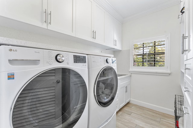 washroom with crown molding, cabinets, separate washer and dryer, and light hardwood / wood-style flooring