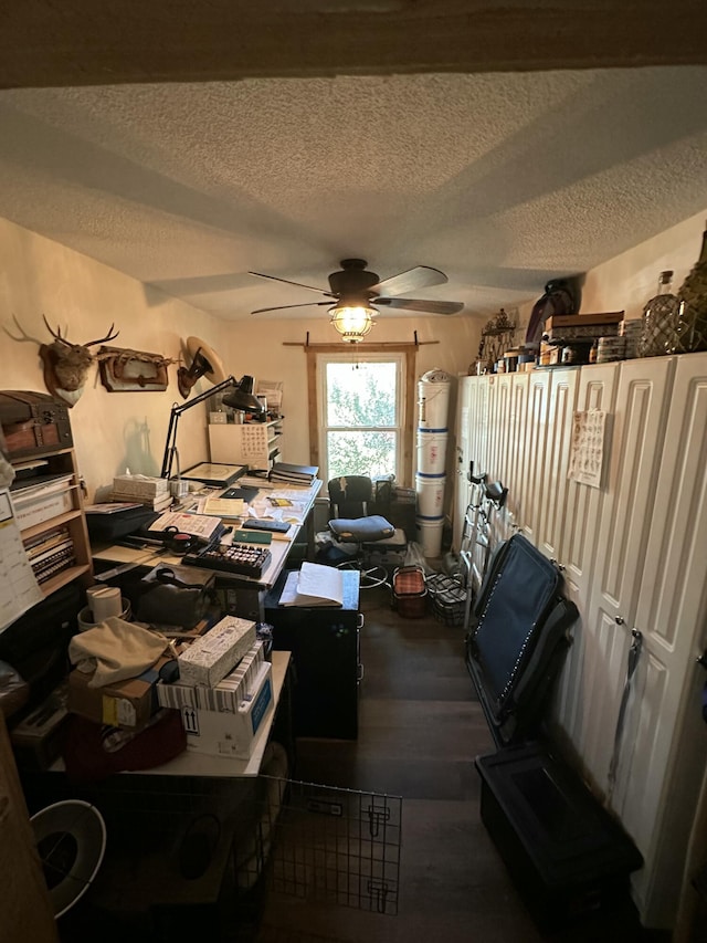 home office featuring ceiling fan, wood-type flooring, and a textured ceiling