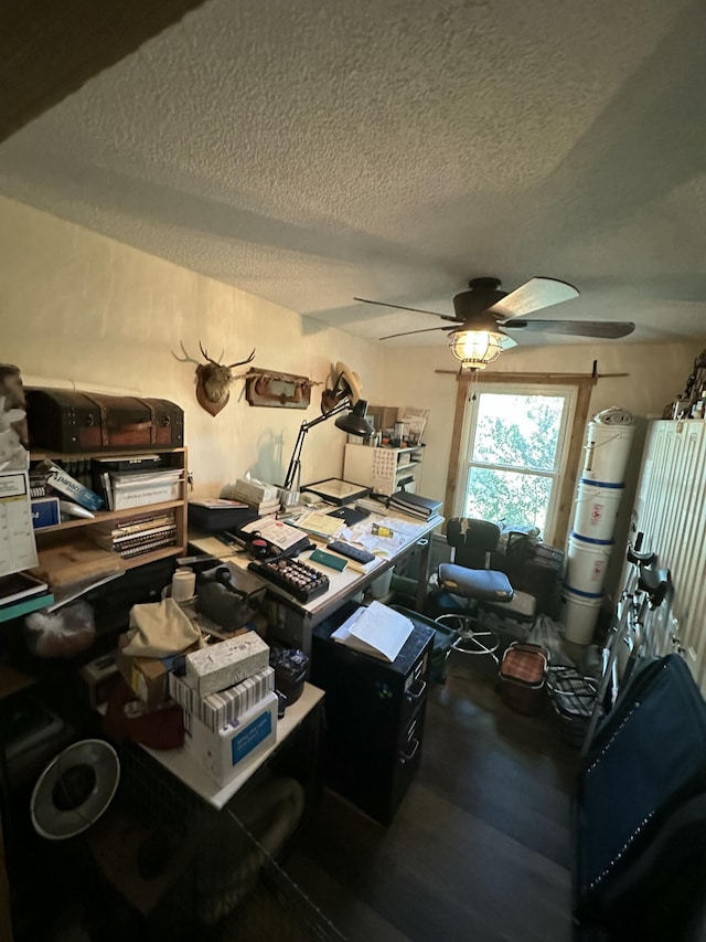 office space with ceiling fan, hardwood / wood-style floors, and a textured ceiling