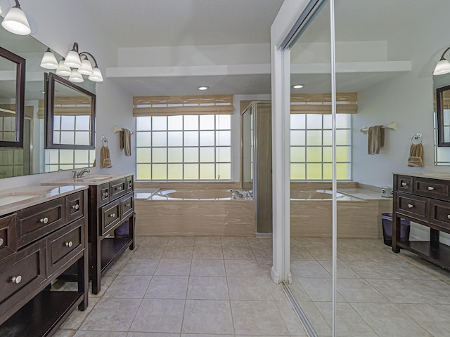 bathroom with tile patterned floors, independent shower and bath, and vanity