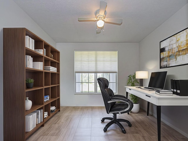 office space with a textured ceiling and ceiling fan