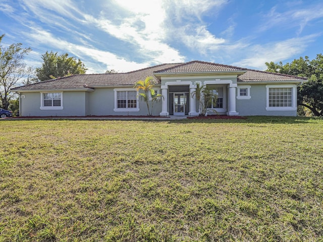 mediterranean / spanish-style house with a front yard