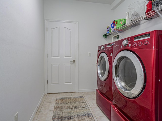 laundry area with washer and clothes dryer and light tile patterned floors