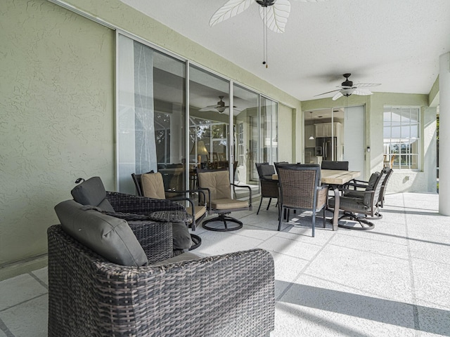 sunroom featuring ceiling fan