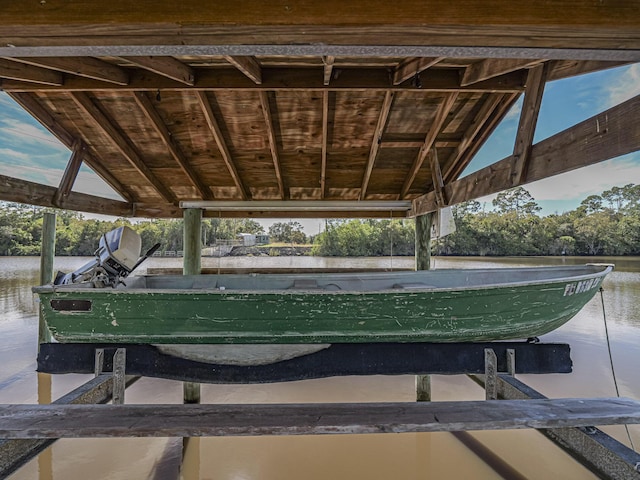 view of community with a water view and a boat dock