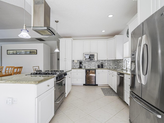 kitchen featuring appliances with stainless steel finishes, backsplash, wine cooler, white cabinets, and decorative light fixtures