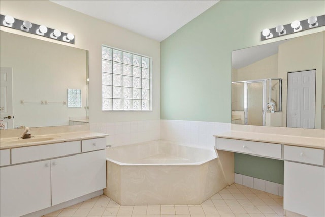 bathroom with lofted ceiling, vanity, tile patterned floors, and plus walk in shower