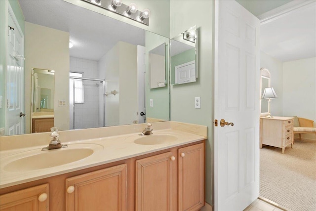 bathroom featuring vanity and an enclosed shower