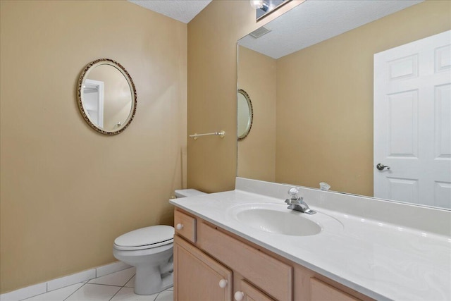 bathroom featuring tile patterned flooring, vanity, and toilet